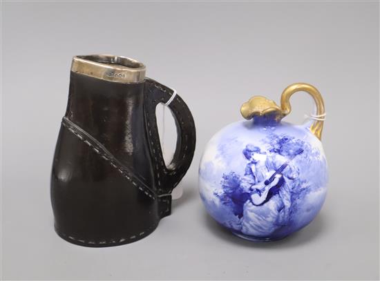 A Royal Doulton Blue Lady jug and a Doulton Black Leather ware jug, with silver mounted rim tallest 16cm (2)